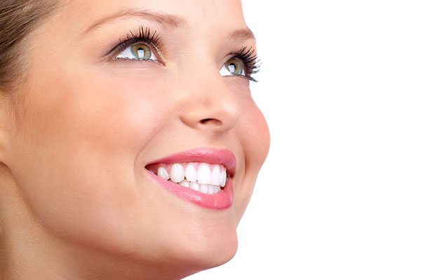 Smiling young woman face with perfect teeth.